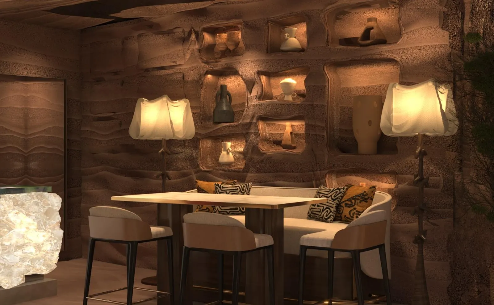 A banquette between two linen floor lamps, carved niches lit along the wall